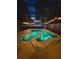 A beautiful pool and jacuzzi lit up at night at 14723 Pine Cone Trl, Clermont, FL 34711