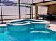 A close-up view of the sparkling blue pool and attached spa, featuring eye-catching mosaic tile accents at 14723 Pine Cone Trl, Clermont, FL 34711