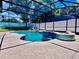 A gorgeous pool and spa are enclosed within a screened patio, offering a backyard oasis with privacy at 14723 Pine Cone Trl, Clermont, FL 34711