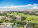 Aerial view showcases lakeside neighborhood with lush green landscapes, mature trees and beautiful residential homes at 16631 Champions Ct, Clermont, FL 34711