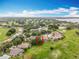 Aerial view showcases this lovely community with lake views and lush green landscape at 16631 Champions Ct, Clermont, FL 34711