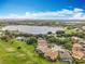 Beautiful lakeside community with lush greenery, single-Gathering homes, and stunning water views at 16631 Champions Ct, Clermont, FL 34711