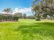 Picturesque view of a well-manicured lawn and mature trees enhancing the property's appeal at 16631 Champions Ct, Clermont, FL 34711