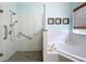 Bright bathroom with a glass enclosed shower and a corner tub at 16631 Champions Ct, Clermont, FL 34711