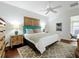 Well-lit bedroom with a blue headboard and two nightstands with lamps at 16631 Champions Ct, Clermont, FL 34711