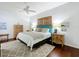 Bedroom featuring a decorative wood blind, wooden floor, and ceiling fan at 16631 Champions Ct, Clermont, FL 34711
