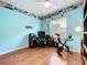 Bedroom features hardwood floors, a ceiling fan, and a window with blinds at 16631 Champions Ct, Clermont, FL 34711
