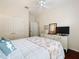 Bedroom boasts hardwood floors, and a comfy bed in a naturally lit space at 16631 Champions Ct, Clermont, FL 34711