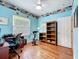 Bedroom featuring light blue walls, hardwood floors, and a ceiling fan at 16631 Champions Ct, Clermont, FL 34711