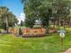 Palisades brick community entrance sign surrounded by mature trees and lush landscaping at 16631 Champions Ct, Clermont, FL 34711