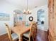 Formal dining room with wood floors, decorative lighting, and a view into other living spaces at 16631 Champions Ct, Clermont, FL 34711