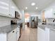 Spacious kitchen with white cabinets, granite countertops, stainless appliances, and tile flooring at 16631 Champions Ct, Clermont, FL 34711