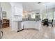 Modern kitchen featuring stainless steel appliances, granite countertops, and white cabinetry at 16631 Champions Ct, Clermont, FL 34711