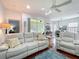 Cozy living room with a reclining sofa, wood floors and view to dining area at 16631 Champions Ct, Clermont, FL 34711