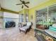 Relaxing outdoor patio featuring comfortable seating, tiled floor, and a ceiling fan at 16631 Champions Ct, Clermont, FL 34711
