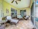 Screened lanai with tile flooring and comfortable wicker furniture set at 16631 Champions Ct, Clermont, FL 34711