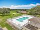 Community pool with golf course views, lounge chairs, and a white picket fence at 16631 Champions Ct, Clermont, FL 34711