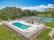 Community pool featuring clean, refreshing water, lounge chairs, and a white picket fence at 16631 Champions Ct, Clermont, FL 34711