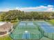 Community tennis and pickleball courts with mature landscaping, pool, and clubhouse at 16631 Champions Ct, Clermont, FL 34711