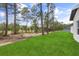 A long strip of green grass runs alongside a home on a treed lot, connecting nature and property at 17485 Sw 41St Cir, Ocala, FL 34473