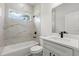 Bathroom featuring tile shower and tub, vanity, and natural light from window at 17485 Sw 41St Cir, Ocala, FL 34473