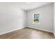 Bedroom featuring wood floors, a neutral color scheme, and natural light from the window at 17485 Sw 41St Cir, Ocala, FL 34473
