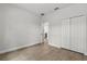 Bedroom features wood floors, closet, neutral colors, and an open doorway at 17485 Sw 41St Cir, Ocala, FL 34473