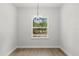Bright dining room features a modern chandelier and window with a serene view of the outdoors at 17485 Sw 41St Cir, Ocala, FL 34473