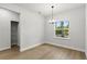 Bright dining room with modern chandelier, closet, and a window offering views of the outdoors at 17485 Sw 41St Cir, Ocala, FL 34473
