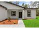 Inviting front entrance with mulched landscaping, creating a welcoming atmosphere to the home at 17485 Sw 41St Cir, Ocala, FL 34473