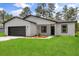Charming one-story home with a well-manicured lawn and beautiful landscaping adds to the curb appeal at 17485 Sw 41St Cir, Ocala, FL 34473