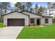 Charming one-story home features a well-manicured lawn, complemented by tasteful landscaping and a two car garage at 17485 Sw 41St Cir, Ocala, FL 34473