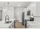 Modern kitchen featuring stainless steel appliances, white cabinets, and center island with elegant faucet at 17485 Sw 41St Cir, Ocala, FL 34473
