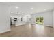 Spacious open-concept living area with modern finishes and a view of the outdoor space through sliding glass doors at 17485 Sw 41St Cir, Ocala, FL 34473