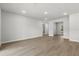 Bright, open living area with wood-look floors leading to other rooms and a window at 17485 Sw 41St Cir, Ocala, FL 34473