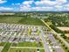 Aerial view of a residential area featuring homes with solar panels, nestled in a well-planned community near open land at 1854 Juneberry St, Clermont, FL 34715