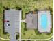 An aerial view of the community pool, parking lot, and surrounding greenery at 1854 Juneberry St, Clermont, FL 34715