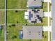 Aerial view of a home with solar panels, a patio, and a spacious backyard in a residential neighborhood at 1854 Juneberry St, Clermont, FL 34715