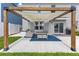 Backyard featuring a modern pergola with shade cover, comfortable seating, and a grill for outdoor entertaining at 1854 Juneberry St, Clermont, FL 34715