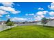 Well-maintained backyard features a lush green lawn, complemented by a white fence for privacy at 1854 Juneberry St, Clermont, FL 34715