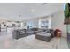 Spacious living room features open concept with kitchen, couch, large rug, and backyard access at 1854 Juneberry St, Clermont, FL 34715