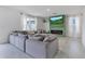 Comfortable living room featuring a cozy gray sectional sofa, electric fireplace, and a large-screen TV at 1854 Juneberry St, Clermont, FL 34715