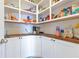 Walk-in pantry with wooden countertops and organized shelving, providing abundant storage at 1854 Juneberry St, Clermont, FL 34715