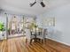 Dining area featuring hardwood floors, glass table and chairs and curtains leading to outdoor patio at 2244 Brookshire Ave, Winter Park, FL 32792