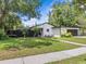 Striking home featuring a sleek black-and-white exterior with well-manicured lawn and modern design at 2244 Brookshire Ave, Winter Park, FL 32792