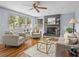Well lit living room with fireplace, hardwood floors, and three large windows at 2244 Brookshire Ave, Winter Park, FL 32792