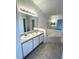 Relaxing primary bathroom features a double vanity, soaking tub, and ample lighting at 2524 Daffadil Ter, Sanford, FL 32771