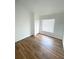 A bright bedroom with wood-look flooring, a closet and a window with blinds at 2524 Daffadil Ter, Sanford, FL 32771