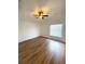 Comfortable bedroom features wood flooring, ceiling fan, and natural light at 2524 Daffadil Ter, Sanford, FL 32771