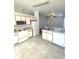 Efficient kitchen features white appliances, tile countertops, and ample cabinet space at 2524 Daffadil Ter, Sanford, FL 32771